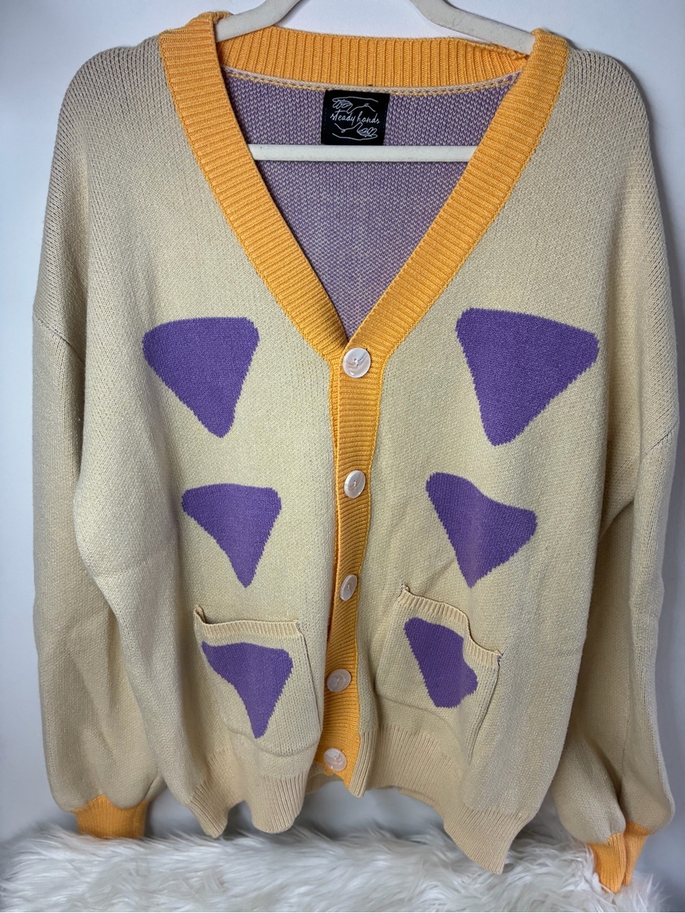 Steady Hands Cream Cardigan with Purple Accent and Yellow Trim